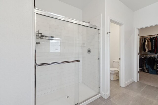 6406 E Giavanna Ave, Fresno, CA 93727 - bathroom with a shower stall, a walk in closet, and tile patterned flooring