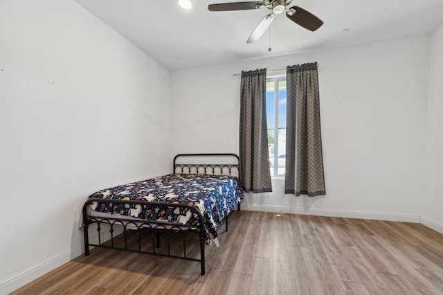 6406 E Giavanna Ave, Fresno, CA 93727 - bedroom featuring wood finished floors, multiple windows, and a ceiling fan