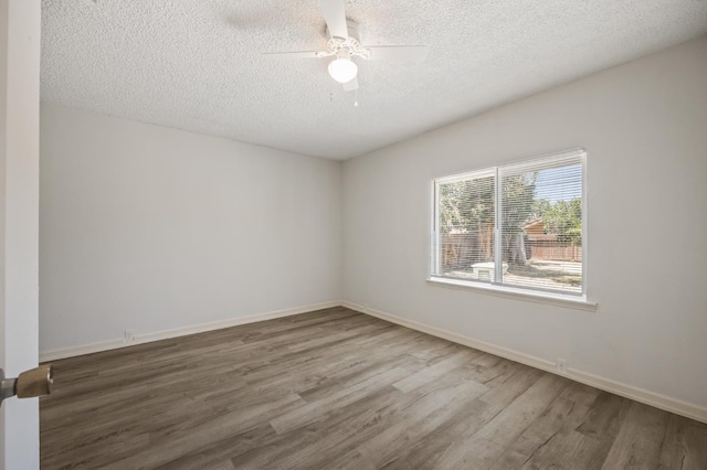 3919 E Butler, Fresno, CA 93702 - unfurnished room with wood finished floors, a textured ceiling, and a ceiling fan