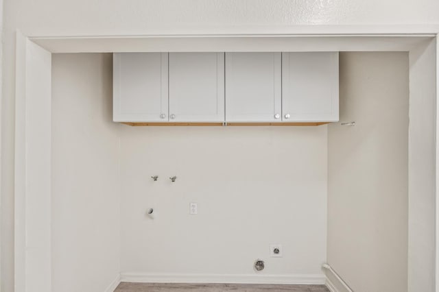 3919 E Butler, Fresno, CA 93702 - laundry area featuring hookup for an electric dryer, cabinet space, wood finished floors, and hookup for a washing machine