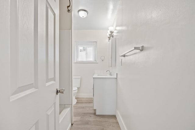 3919 E Butler, Fresno, CA 93702 - full bathroom featuring vanity, wood finished floors, and washtub / shower combination