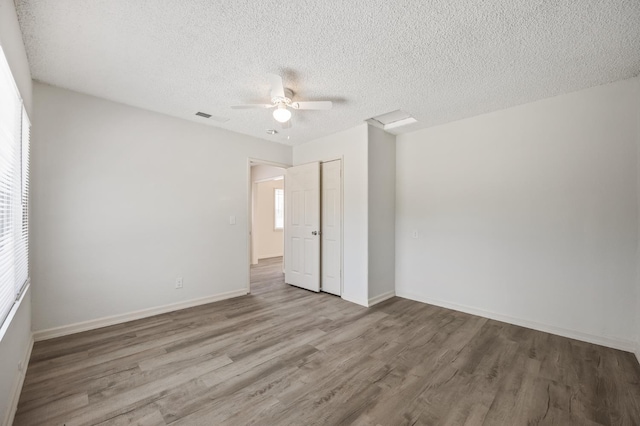 3919 E Butler, Fresno, CA 93702 - empty room featuring wood finished floors, a ceiling fan, and a textured ceiling