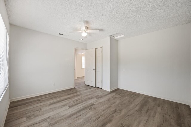 3919 E Butler, Fresno, CA 93702 - empty room featuring wood finished floors, a ceiling fan, and a textured ceiling