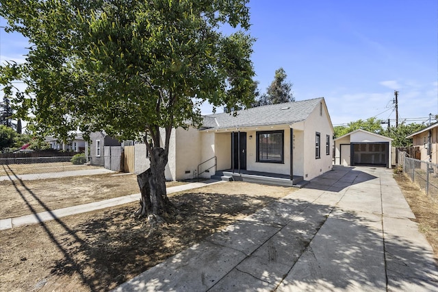 3919 E Butler, Fresno, CA 93702 - view of front of home featuring concrete driveway, stucco siding, a garage, and an outbuilding
