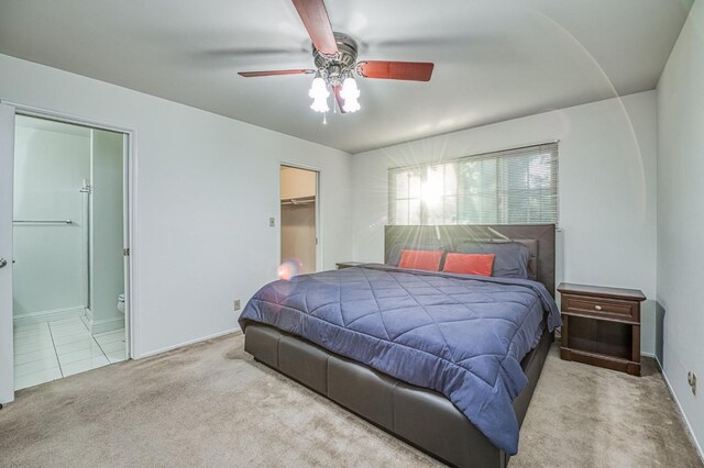 6482 N 5th St, Fresno, CA 93710 - carpeted bedroom with a walk in closet, ceiling fan, and connected bathroom