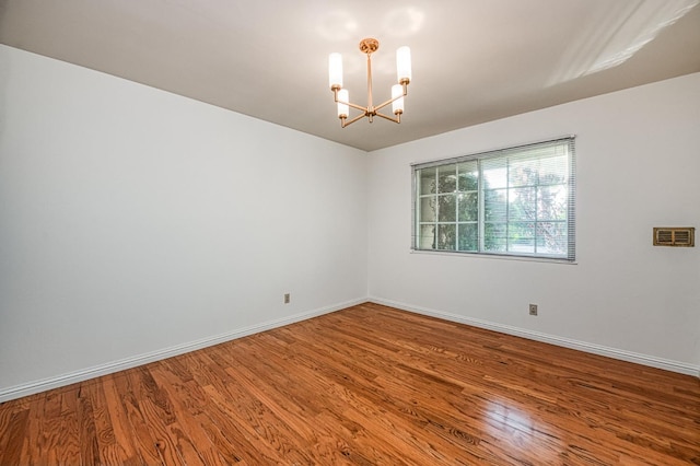6482 N 5th St, Fresno, CA 93710 - empty room featuring a chandelier and wood finished floors