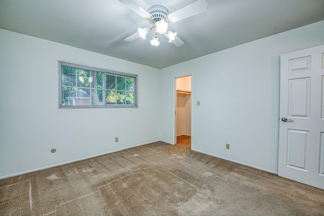 6482 N 5th St, Fresno, CA 93710 - unfurnished bedroom featuring carpet flooring, a walk in closet, and a ceiling fan