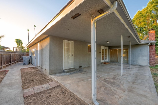 6482 N 5th St, Fresno, CA 93710 - rear view of house with stucco siding, a patio, french doors, and a chimney