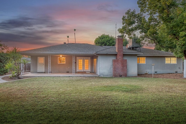 6482 N 5th St, Fresno, CA 93710 - back of house at dusk featuring french doors, stucco siding, a chimney, roof with shingles, and crawl space