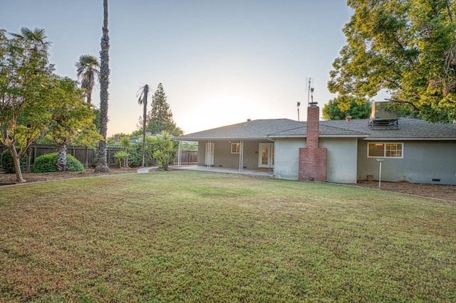 6482 N 5th St, Fresno, CA 93710 - back of house at dusk featuring a chimney, a patio area, and stucco siding