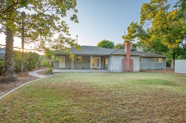 6482 N 5th St, Fresno, CA 93710 - rear view of property featuring a lawn, stucco siding, a shingled roof, and a chimney