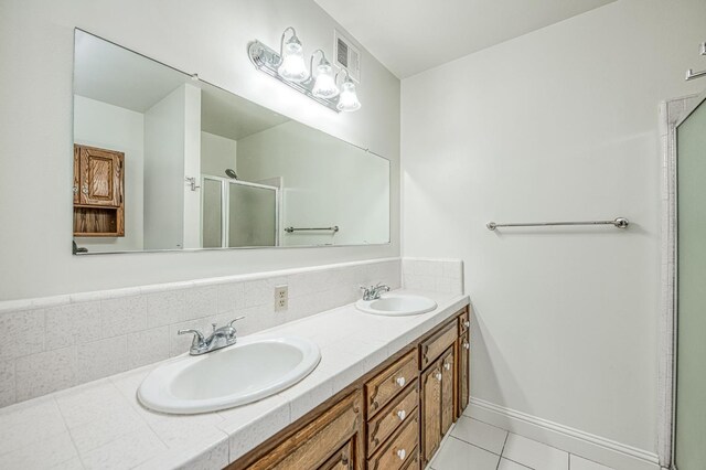 6482 N 5th St, Fresno, CA 93710 - bathroom featuring double vanity, a stall shower, and tile patterned floors