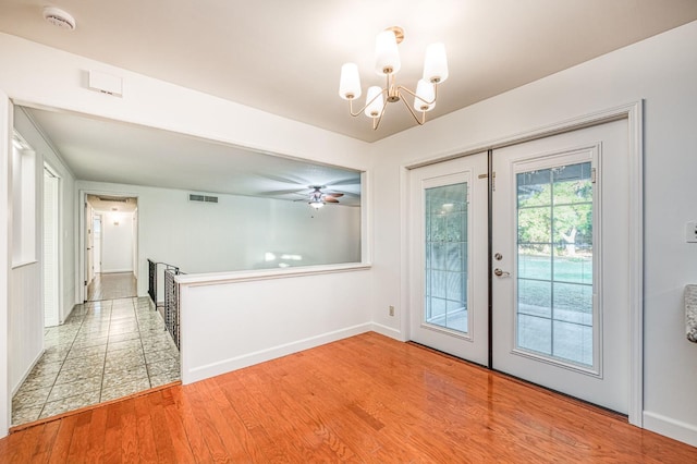 6482 N 5th St, Fresno, CA 93710 - entryway featuring a chandelier, ceiling fan, light wood finished floors, and french doors