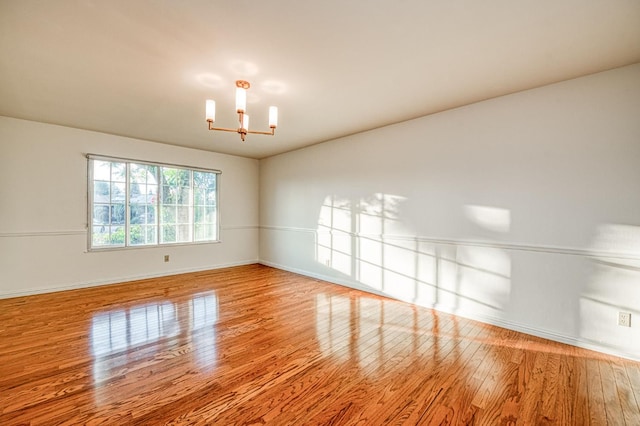 6482 N 5th St, Fresno, CA 93710 - unfurnished room featuring wood finished floors and a chandelier