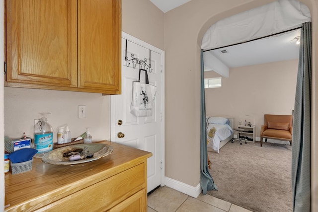 1085 Stanford Ave, Madera, CA 93637 - kitchen with light tile patterned floors, light carpet, open floor plan, and butcher block counters