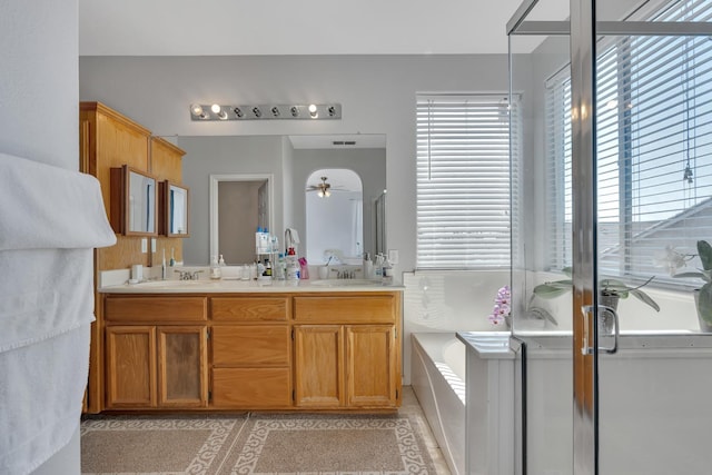 1085 Stanford Ave, Madera, CA 93637 - full bath featuring a ceiling fan, double vanity, a bath, and tile patterned floors