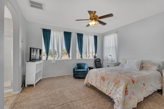 1085 Stanford Ave, Madera, CA 93637 - carpeted bedroom with multiple windows, arched walkways, and a ceiling fan