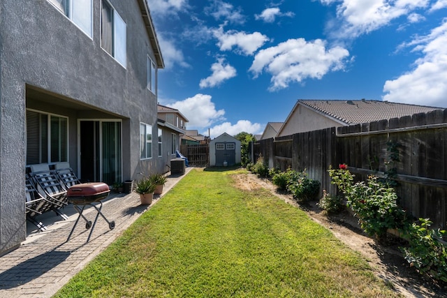 1085 Stanford Ave, Madera, CA 93637 - fenced backyard featuring a shed, a patio, and a residential view