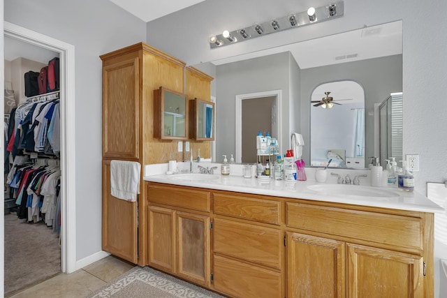 1085 Stanford Ave, Madera, CA 93637 - bathroom with ceiling fan, double vanity, a walk in closet, tile patterned flooring, and a shower stall