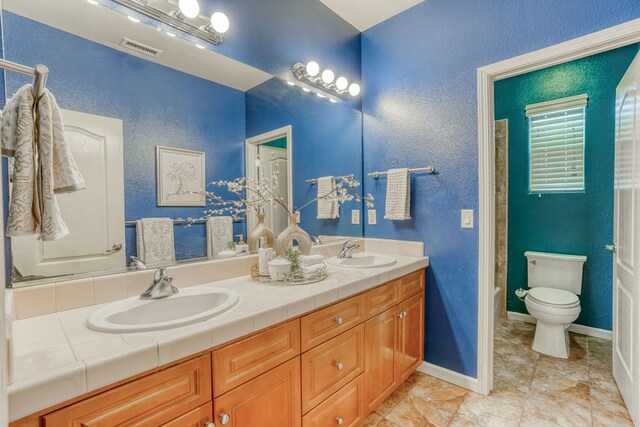 3202 Everglade Ave, Clovis, CA 93619 - bathroom featuring double vanity and a textured wall