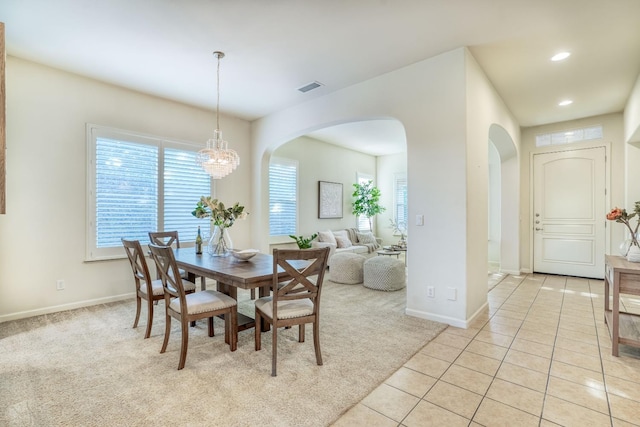 3202 Everglade Ave, Clovis, CA 93619 - dining space with arched walkways, light colored carpet, recessed lighting, a chandelier, and light tile patterned floors