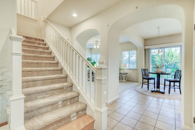 3202 Everglade Ave, Clovis, CA 93619 - stairway featuring arched walkways, a ceiling fan, tile patterned floors, and recessed lighting