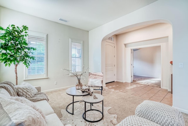 3202 Everglade Ave, Clovis, CA 93619 - carpeted living area featuring arched walkways and tile patterned flooring