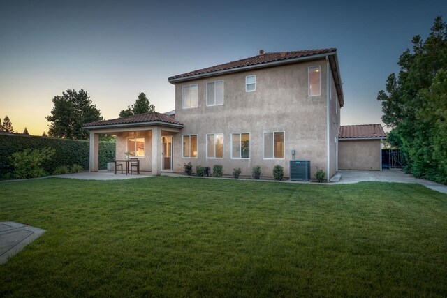 3202 Everglade Ave, Clovis, CA 93619 - back of property at dusk with a patio area, a tile roof, and stucco siding