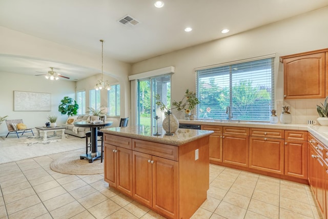 3202 Everglade Ave, Clovis, CA 93619 - kitchen featuring light tile patterned floors, open floor plan, recessed lighting, a center island, and hanging light fixtures