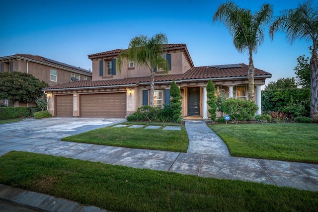 3202 Everglade Ave, Clovis, CA 93619 - mediterranean / spanish-style home with solar panels, a front yard, a tile roof, concrete driveway, and stucco siding
