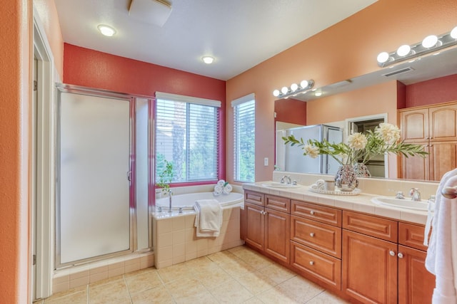 3202 Everglade Ave, Clovis, CA 93619 - full bathroom with double vanity, a stall shower, a garden tub, and tile patterned flooring