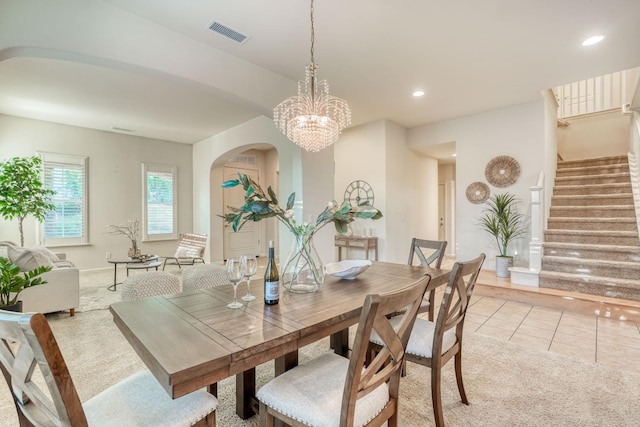 3202 Everglade Ave, Clovis, CA 93619 - dining room with light colored carpet, stairway, light tile patterned floors, arched walkways, and a chandelier