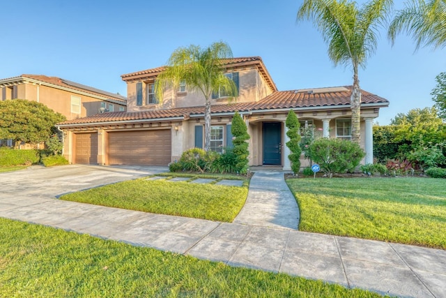 3202 Everglade Ave, Clovis, CA 93619 - mediterranean / spanish-style home with a tile roof, concrete driveway, stucco siding, a front lawn, and an attached garage