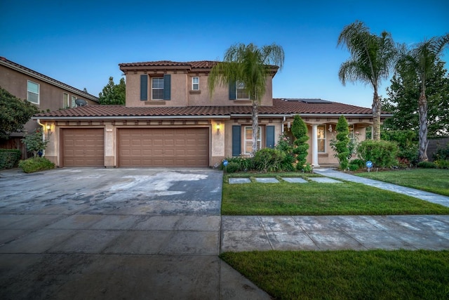 3202 Everglade Ave, Clovis, CA 93619 - mediterranean / spanish-style house with a front lawn, driveway, roof mounted solar panels, stucco siding, and a tile roof