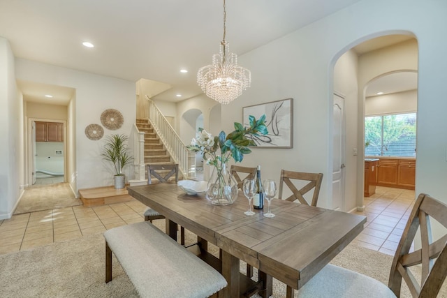 3202 Everglade Ave, Clovis, CA 93619 - dining room featuring light tile patterned floors, arched walkways, stairs, recessed lighting, and a chandelier