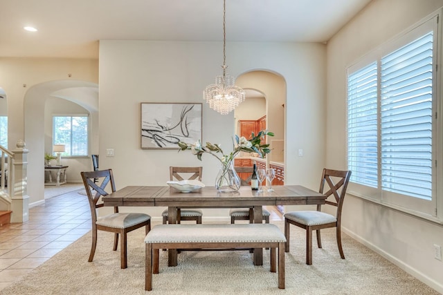 3202 Everglade Ave, Clovis, CA 93619 - dining area featuring arched walkways, a chandelier, light tile patterned floors, and recessed lighting