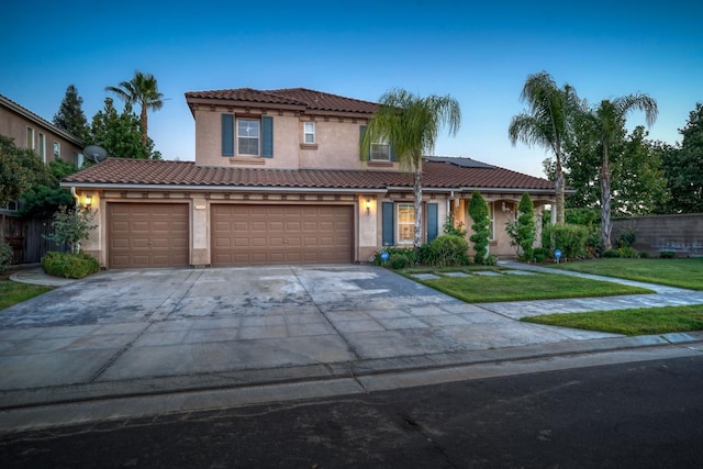 3202 Everglade Ave, Clovis, CA 93619 - mediterranean / spanish home with stucco siding, driveway, roof mounted solar panels, an attached garage, and a tile roof