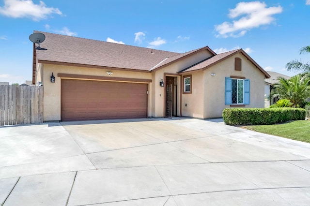976 Daisy Ct, Dinuba, CA 93618 - view of front of property with stucco siding, a garage, driveway, and roof with shingles