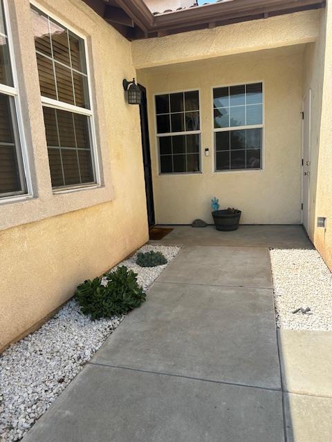 2400 Garda Corte, Chowchilla, CA 93610 - entrance to property with stucco siding and a patio