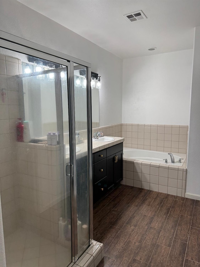 2400 Garda Corte, Chowchilla, CA 93610 - bathroom with vanity, a garden tub, a stall shower, and wood finished floors