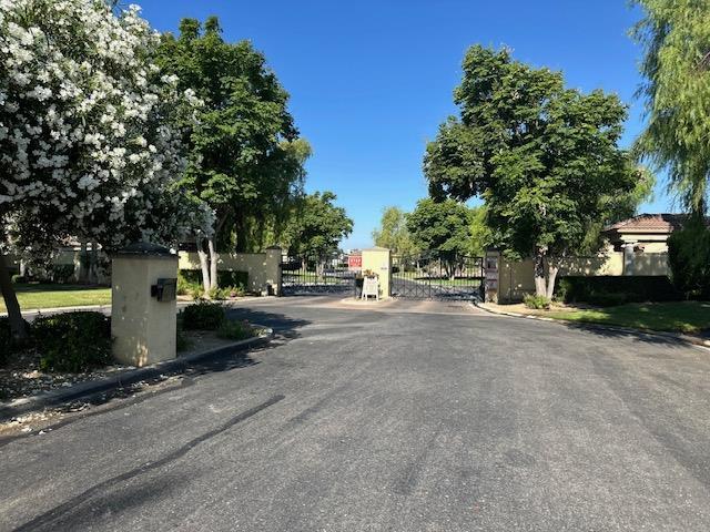 2400 Garda Corte, Chowchilla, CA 93610 - view of asphalt road featuring curbs, a gate, and a gated entry