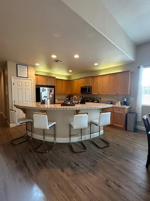 2400 Garda Corte, Chowchilla, CA 93610 - kitchen with stainless steel microwave, freestanding refrigerator, tile countertops, dark wood-type flooring, and recessed lighting
