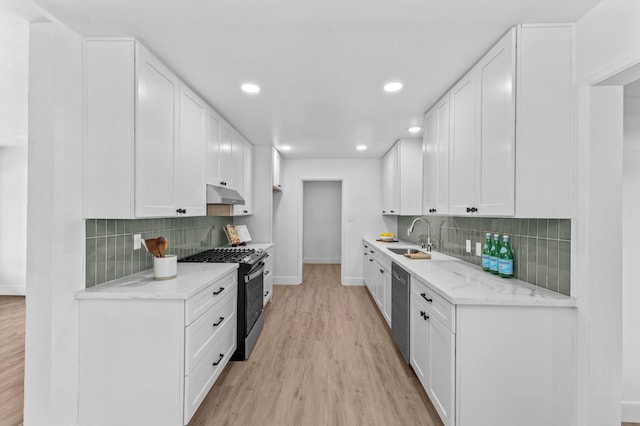 644 W Yale Ave, Fresno, CA 93705 - kitchen featuring appliances with stainless steel finishes, under cabinet range hood, light wood finished floors, backsplash, and recessed lighting