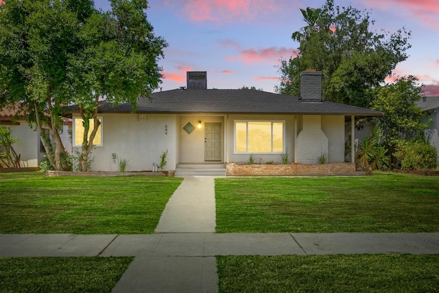 644 W Yale Ave, Fresno, CA 93705 - single story home featuring a chimney, a yard, and stucco siding