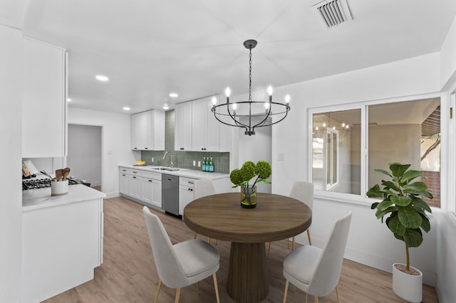 644 W Yale Ave, Fresno, CA 93705 - dining room with a chandelier, light wood-style floors, recessed lighting, and healthy amount of natural light