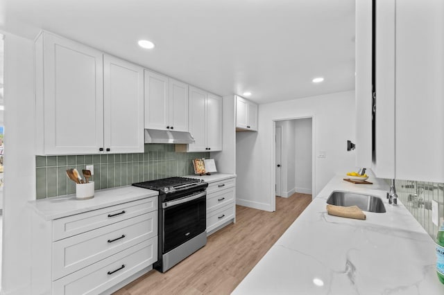 644 W Yale Ave, Fresno, CA 93705 - kitchen featuring stainless steel range with gas stovetop, under cabinet range hood, backsplash, white cabinets, and recessed lighting