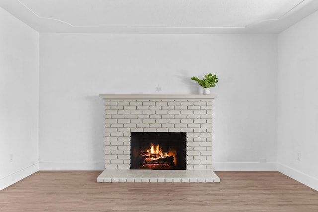 644 W Yale Ave, Fresno, CA 93705 - detailed view of a brick fireplace and wood finished floors
