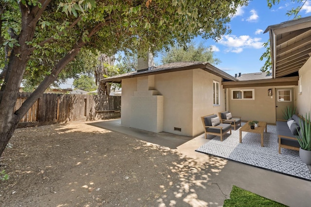 644 W Yale Ave, Fresno, CA 93705 - back of property with an outdoor living space, a patio, a chimney, and stucco siding
