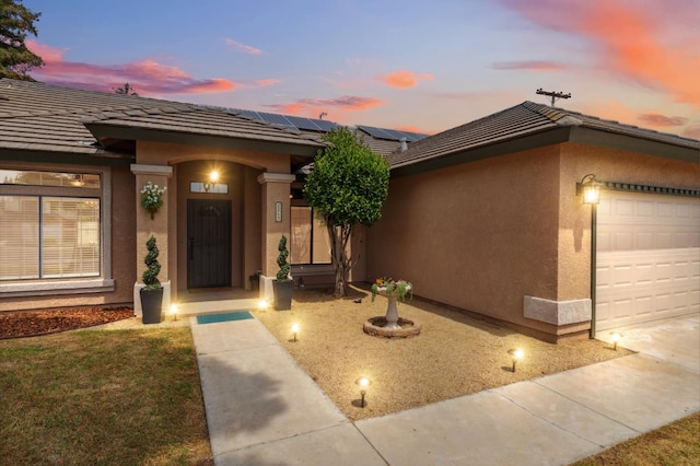 2261 Magill Ave, Clovis, CA 93611 - view of front of home with stucco siding, a garage, and a tile roof