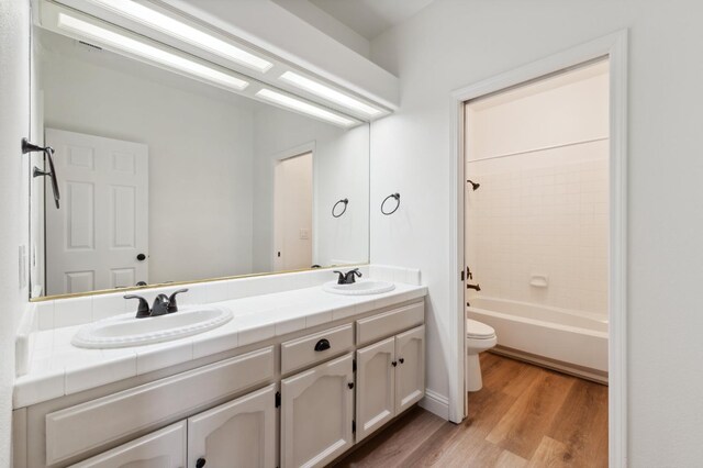 2261 Magill Ave, Clovis, CA 93611 - full bath with double vanity, wood finished floors, and shower / bathtub combination